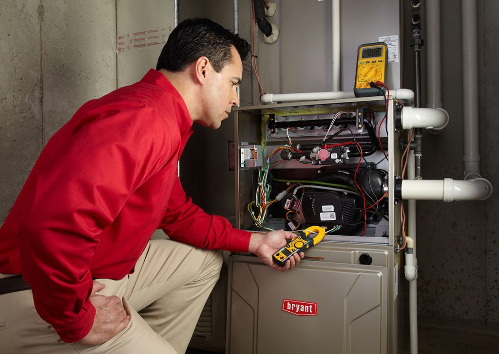 HVAC technician repairing an indoor furnace in Sun City