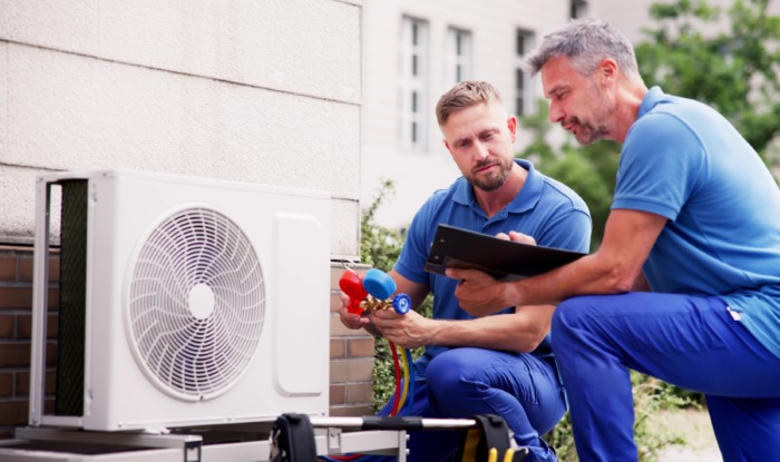 HVAC technicians installing an outdoor air conditioning unit in Sun City