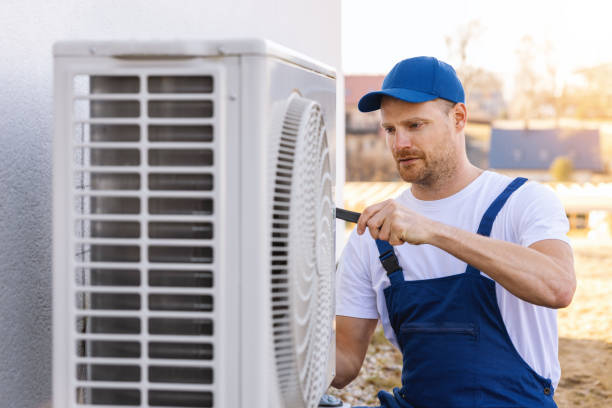 HVAC technician servicing an outdoor air conditioning unit in Sun City