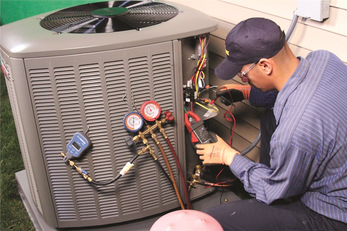 HVAC technician testing an outdoor air conditioning unit in Sun City